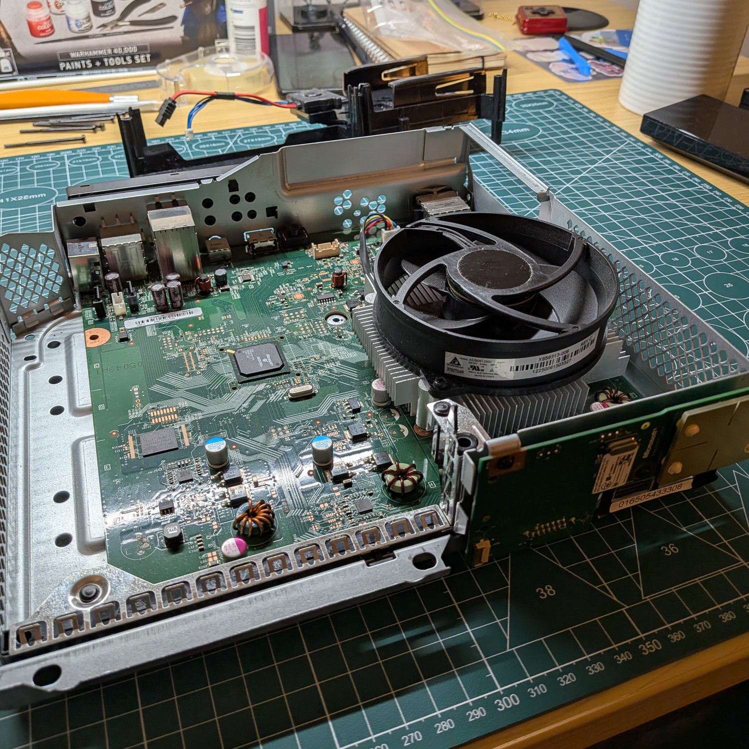 the xbox 360 motherboard sitting in its steel enclosure